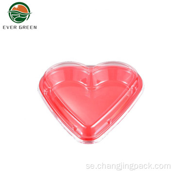Engångs röda hjärtformad plast tar ut matbehållaren
